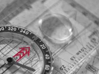 Compass laid over a map | Atradius