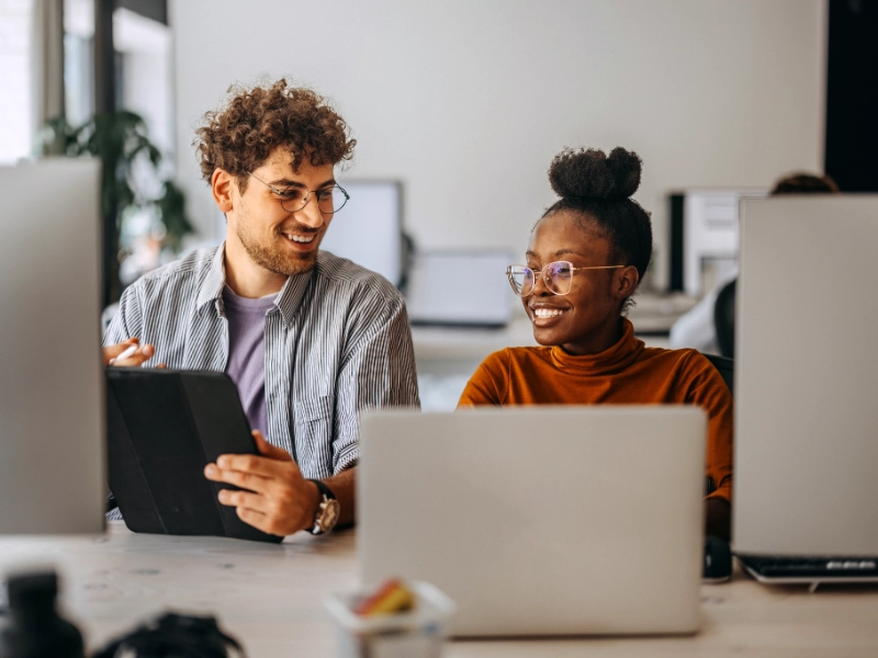 woman and man behind computers