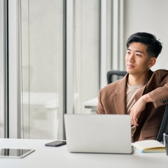 man behind desk with laptop