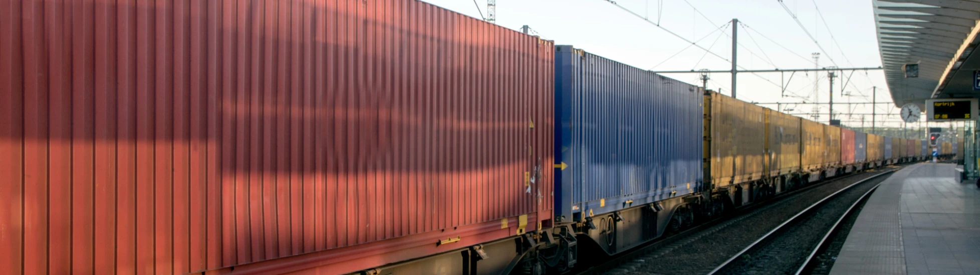 Freight train passing through a station