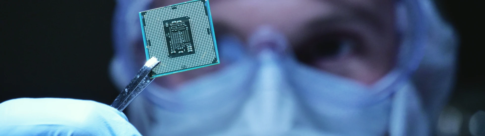 holding up a microchip in closeup