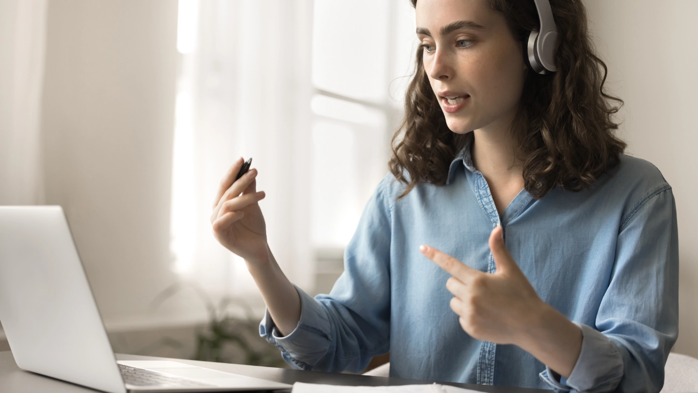 woman at laptop with a headset woman at laptop with a headset