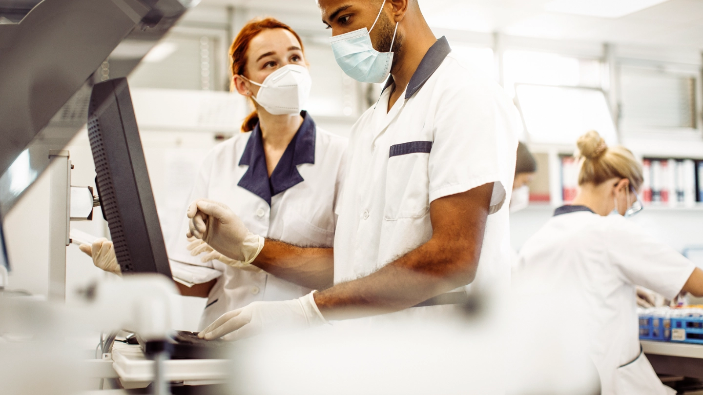 Laboratory workers discussing results image