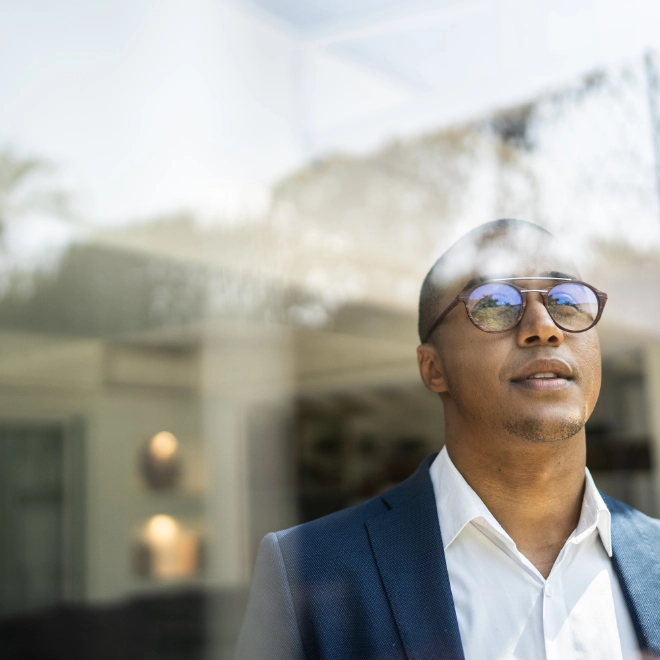 man looking out of window
