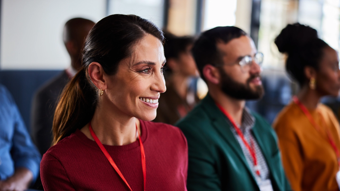 Smiling woman attending a business seminar